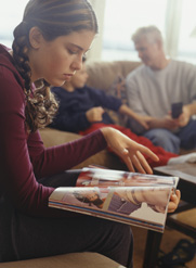 sad girl looking at a magazine