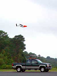 Aerosonde soars over a pickup truck at launching
