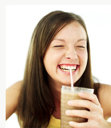 a girl drinking milk and smiling