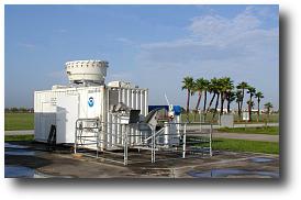 NPCO deployed in Florida for CRYSTAL-FACE.  The white seatainer contains the MMCR radar, data systems and instrument control computers.  The MMCR antenna is the drum visible on top.  The fenced pen in the foreground contains the radiometers.