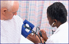 A nurse checking a patients blood pressure
