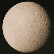 This view of Tethys was taken by Voyager 2 on August 26, 1981. It is the highest resolution image acquired by the Voyager spacecraft. An enormous trench named Ithaca Chasma extends from the left side of this image to the upper center.