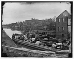 Richmond, Va. Barges with African Americans on the Canal; ruined buildings beyond