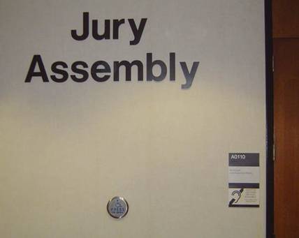 Jury Assembly room with power opening door and signage indicating availability of assistive listening systems