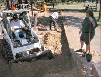 Figure 2—Removal of sand from existing playground surface.