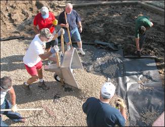 Figure 3 —Placement of drainage fabric and rock on playground subsurface. 