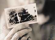 Picture of elderly person holding photograph of ancestor.