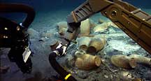 The high-tech arm of the undersea robot HERCULES investigates ancient shipping jars at the site of a Byzantine-era shipwreck. 