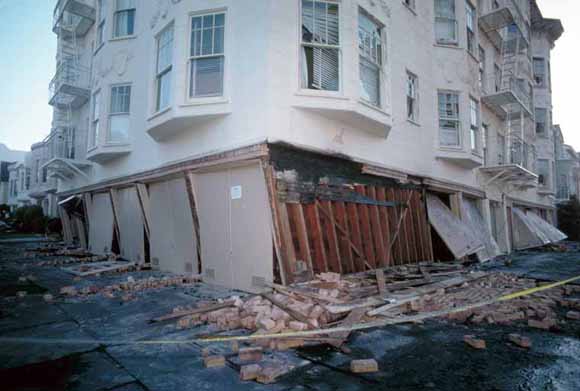 two-story building with bottom story nearly collapsed