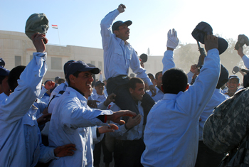 Baghdad's newest class of Iraqi policemen celebrate with unrestrained joy after their graduation ceremony, Feb. 21, at the Furat Iraqi Police Training Academy in Baghdad. The ceremony marked the inaugural graduation from the two-week course. (U.S. Army photo/by Spc. Elvyn Nieves)