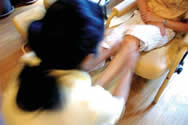 Photo of Pa, who is HIV
-positive, gives a foot massage in her Bangkok parlor, funded through the Positive Partnerships Program, which gives loans to business partners, one of whom is HIV-positive and the other HIV
-negative(click here to read more).