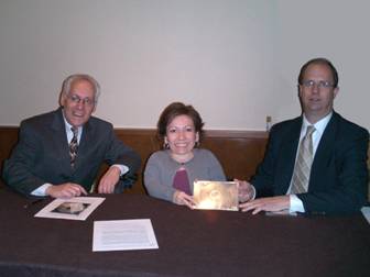 Photo of TEITAC co-chairs Jim Tobias and Mike Paciello presenting the committee's report to Board chair Tricia Mason