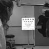 An NEI-certified ophthalmic technician uses the ETDRS eye chart 