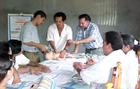 Photo of a group of people learning to administer CPR.