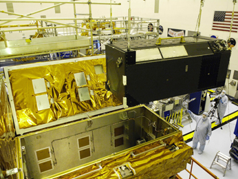 the Cosmic Origins Spectrograph, is carefully installed into its Scientific Instrument Protective Enclosure