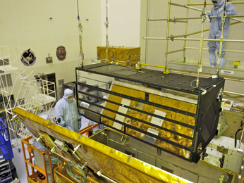 the Cosmic Origins Spectrograph, is carefully installed into its Scientific Instrument Protective Enclosure