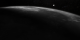 The LRO spacecraft traverses from darkness into daylight.