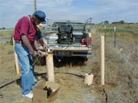 Idaho Department of Environmental Quality scientist and a landowner (behind the first person) are taking a water-level measurement from a well that’s part of the network used for the National Ground-Water Reconnaissance for Emerging Contaminants Project