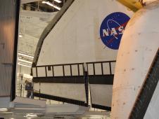 Technician watches clearance for space shuttle Endeavour's wing.
