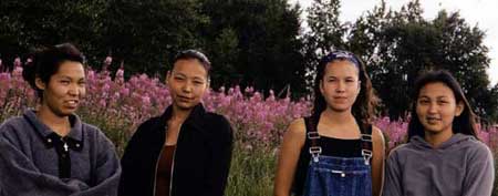 Posing in front of the beautiful fireweed are Kristy Balluta, Janell Kakaruk, and Shavela Stickman of Nondalton, and Crystal Wassillie of Newhalen.