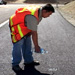 Photo: KCDOT engineer pours water on  porous asphalt works