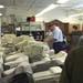 Photo:  Customer inspects items prior to auction