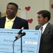 Photo:  King County Executive Ron Sims and Marcos Sanidad hold donation check from Lillian Hyde