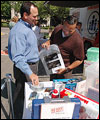Photo of man handing out disaster supplies.