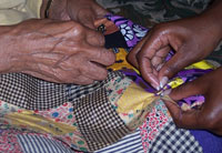 Women work on a quilt for the exhibition.