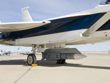 An inert Phoenix missile nestled under the fuselage of NASA Dryden's F-15B aircraft is being studied as a possible test vehicle to obtain hypersonic data.