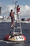 Image of TAO personnel repairing buoy instrumentation
