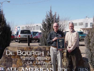 Bill Dutro, Vice President for Operations-DeBourgh (left), and Del Sandfort, Colorado 21d Project Manager, with SHARP plaque outside of the company.