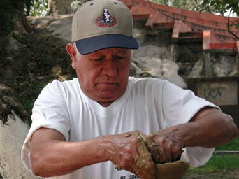 Photo of An artisan from   Ilobasco, Cabanas, works on a clay piece.  He is a beneficiary of USAID’s   Artisan Development Program.