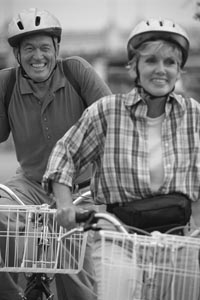 Photo of man and woman bicycling.