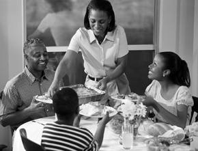 Picture of mother serving her family at the dining table