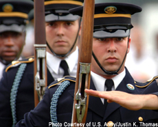 Photograph of a U.S. Army Drill Team executing precision drill movements during a festival