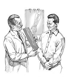 Doctor examines x-ray with patient