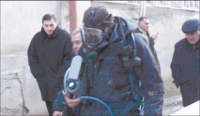 Photograph of H M R U personnel about to enter the apartment where the officials’ bodies were found 