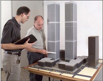 Photograph of employees from the Laboratory's Structural Design Unit examine a model of the World Trade Center Towers