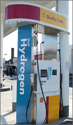 Photo of a hydrogen fueling pump. The top of the pump is red and yellow with the text Quality Fuels. The facing side of the pump is blue with the text Shell Hydrogen.