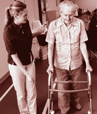 Image of therapist helping man in walker