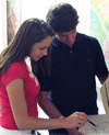 Hollings scholarship 
summer students studying book of historical weather maps