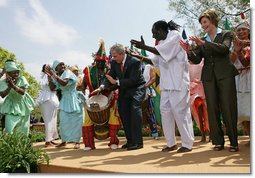 President George W. Bush and Mrs. Laura Bush take the stage with the Kankouran West African Dance Company after delivering remarks during a ceremony marking Malaria Awareness Day Wednesday, April 25, 2007, in the Rose Garden.  White House photo by Eric Draper
