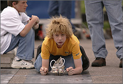 Photo of student getting ready to race his solar car at the U.S. Department of Energy's Junior Solar Sprint/Hydrogen Fuel Cell (JSS/HFC) Car Competitions.