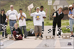 Photo of students racing their solar cars at the U.S. Department of Energy's Junior Solar Sprint/Hydrogen Fuel Cell (JSS/HFC) Car Competitions.