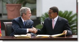 President George W. Bush and President Jakaya Kikwete of Tanzania, shake hands after signing the $698 million Millennium Challenge Compact Sunday, Feb. 17, 2008, in Dar es Salaam. In signing the compact, President Bush said, "We are partners in democracy. We believe that governments ought to respond to the people. We're also partners in fighting disease, extending opportunity and working for peace. Mr. President, I mentioned I was proud to sign, along with the President, the largest Millennium Challenge Account in the history of the United States here in Tanzania. It will provide nearly $700 million over five years to improve Tanzania's transportation network, secure reliable supplies of energy, and expand access to clean and safe water." White House photo by Chris Greenberg