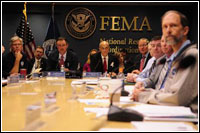 FEMA Administrator R. David Paulison (L red tie) is joined by Department of Homeland Security Secretary, Michael Chertoff (c) and FEMA Deputy Administrator Harvey Johnson (r) as they conduct a Video Tele-Conference on Hurricane Ike. Barry Bahler/FEMA  