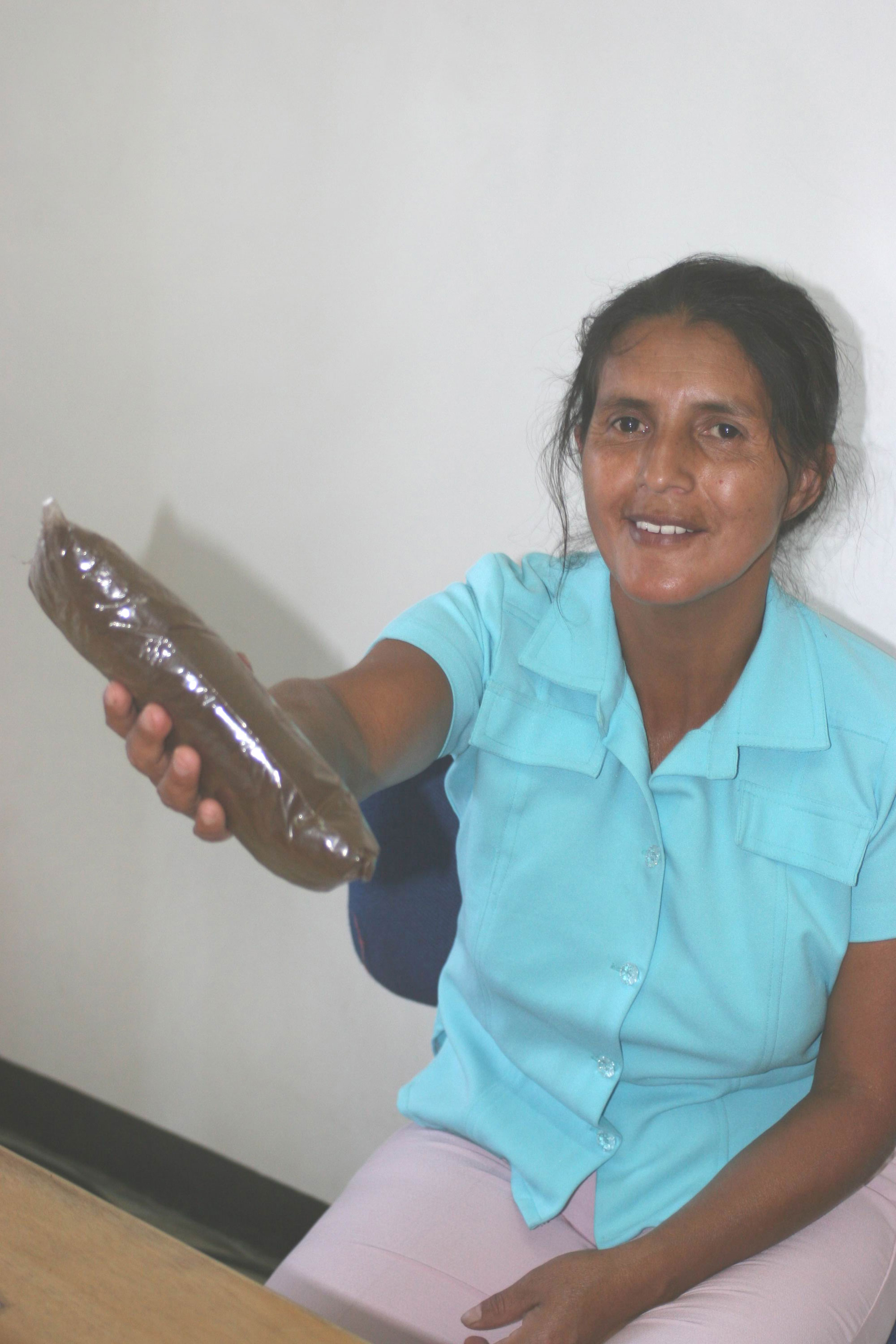 Norys Pechinché displays panela sugar produced in her village.