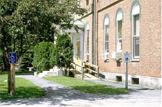 Wooden ramp constructed to provide an accessible route to the entrance platform of an existing public building