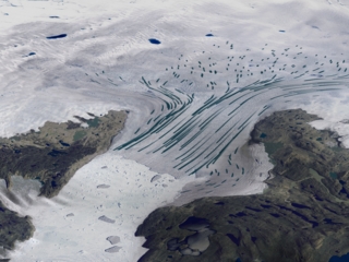 This image, showing the flow of glacial ice toward the ocean, was derived from ERS SAR measurements.  The flow rate of the Jakobshavn Glacier more than doubled over the period from 1997 to 2003.  